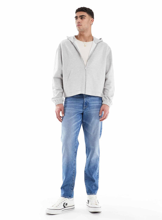 ASOS DESIGN tapered jeans in light wash blue