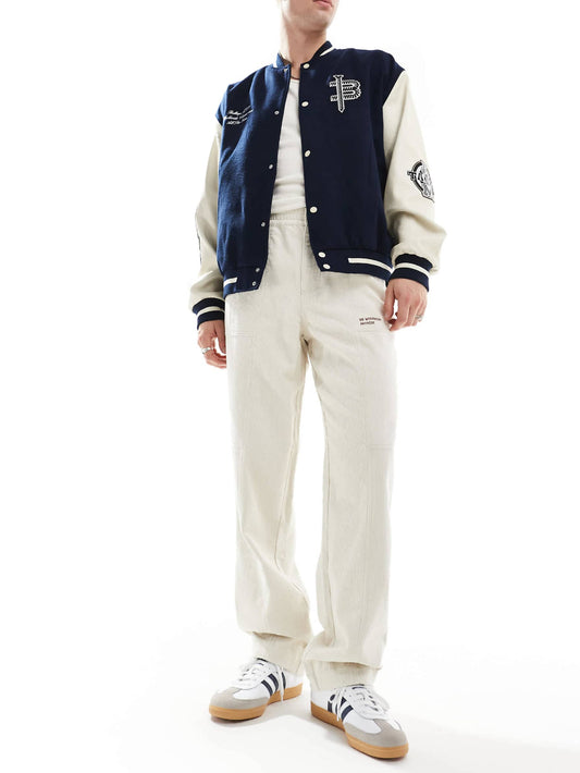 ASOS DESIGN baggy cord trousers with embroidered patch in stone